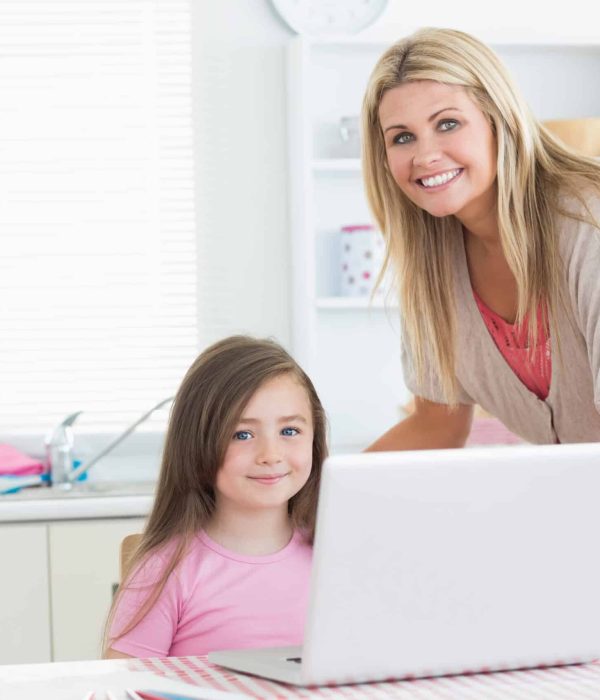 Mother,And,Child,In,The,Kitchen,Smiling,With,A,Laptop