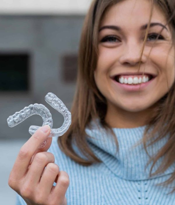 Caucasian,Woman,With,White,Smile,Holding,Transparent,Removable,Retainer.,Bite