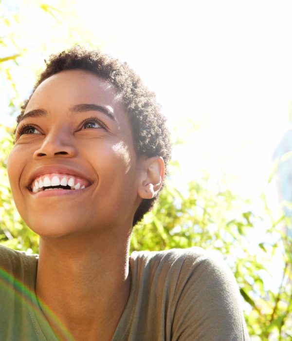 Close,Up,Portrait,Of,Beautiful,Young,Black,Woman,Smiling,Outdoors